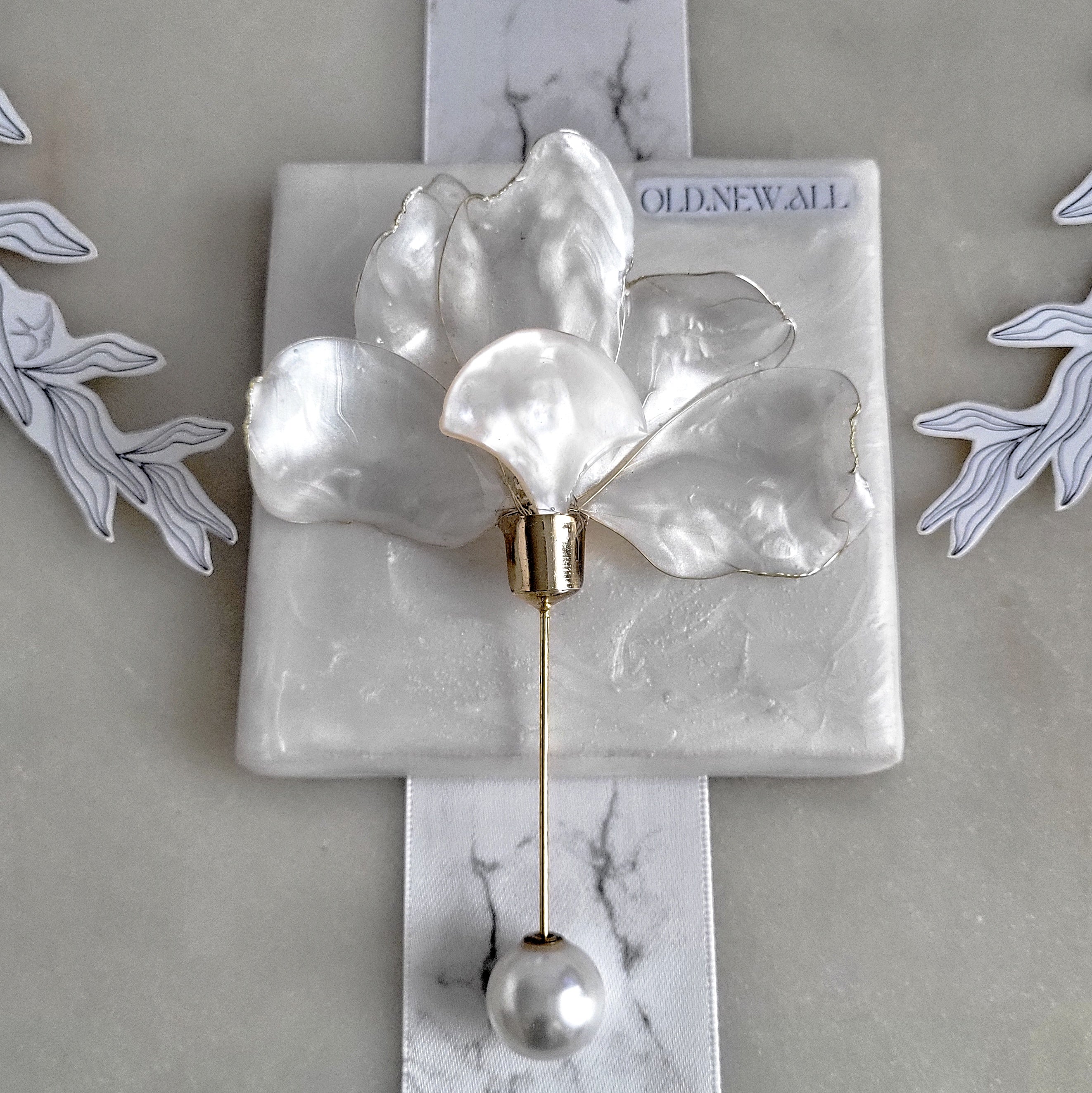 Handcrafted extra large mother of pearl silk flower brooch in white orchid design with gold wire petals and secure pin findings.
