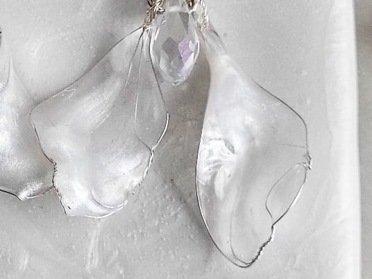 close up Handcrafted white mother-of-pearl resin earrings on silver french hooks with clear crystal suncatcher waterdrops