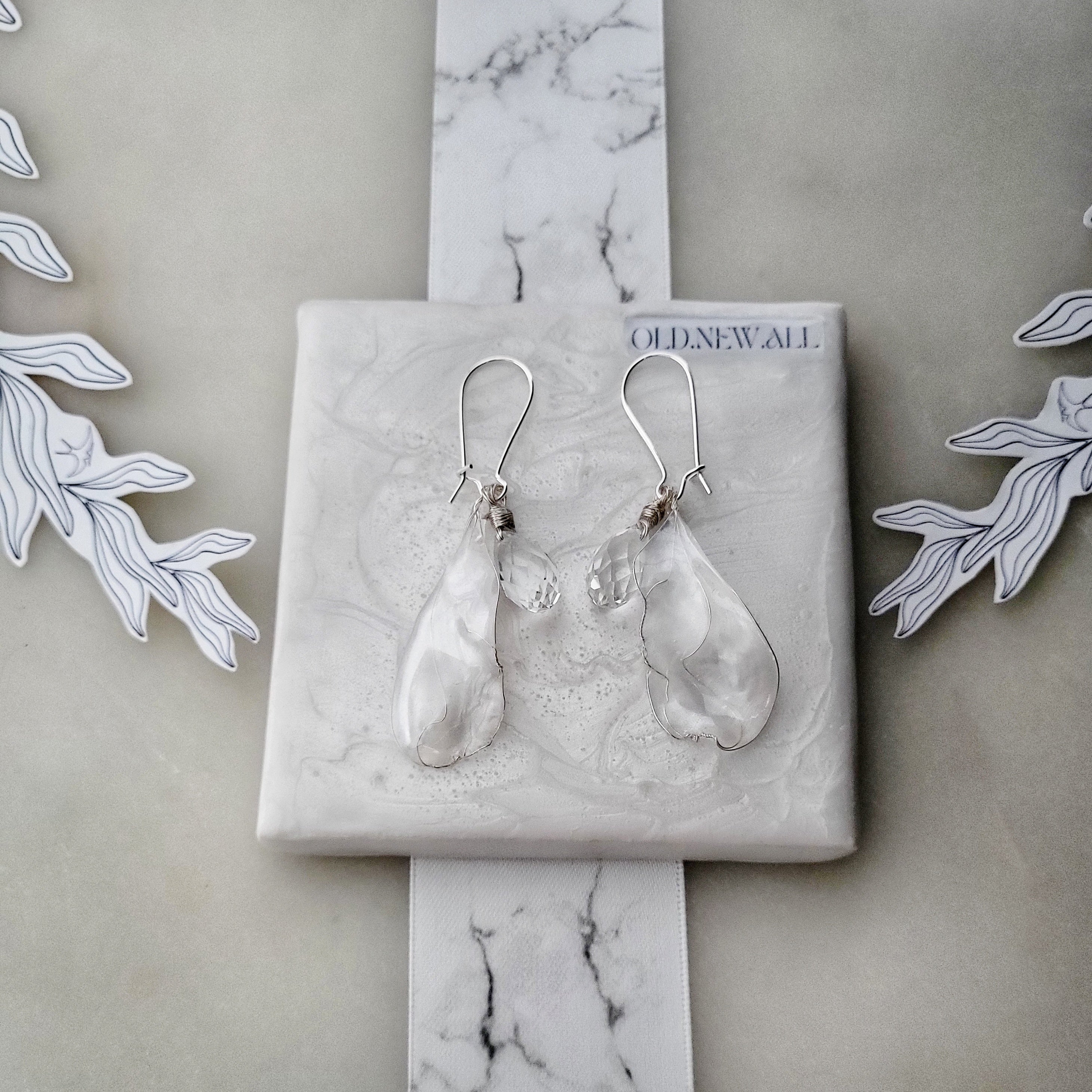 Handcrafted white mother-of-pearl resin earrings on silver french hooks with clear crystal suncatcher waterdrops