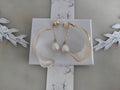 Handcrafted white pearl studs with an embedded gold heart, featuring a delicate chain with a twisted wire white resin petal drop design.