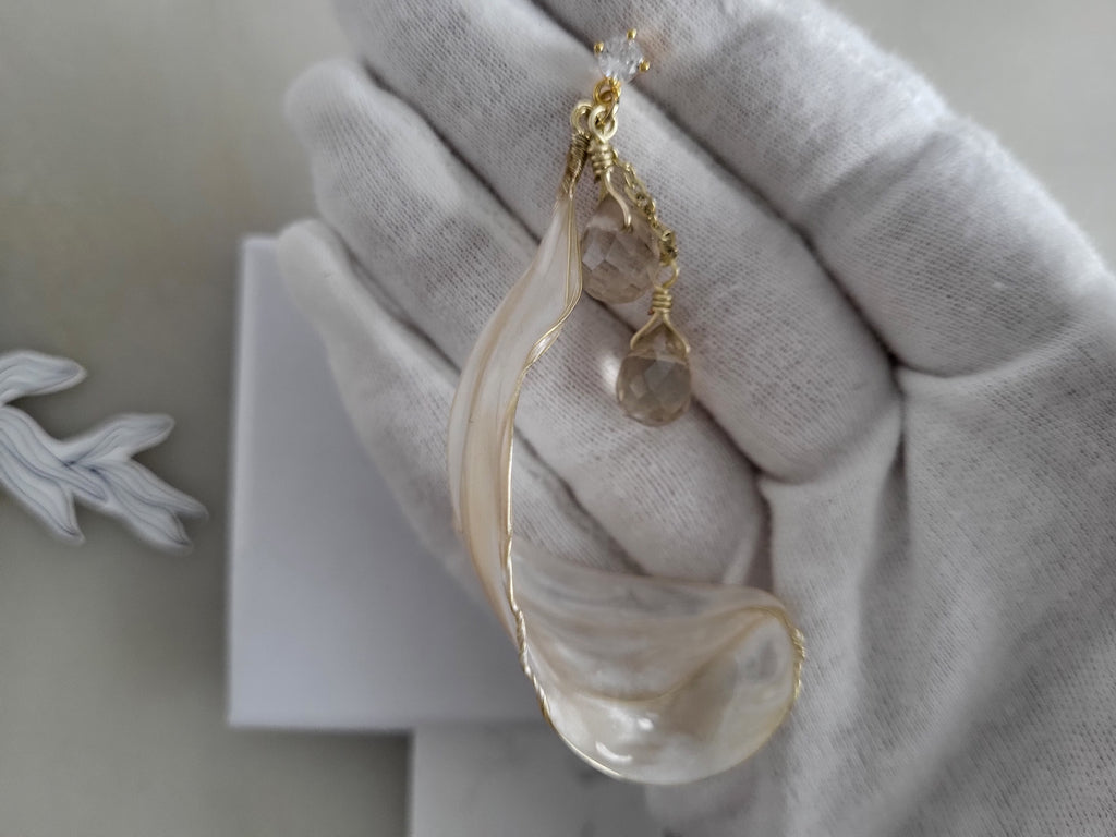 Handcrafted long gold wire earrings with ivory mother of pearl resin flowers on a delicate chain with sparkling champagne crystal drops.