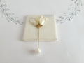 Handcrafted extra large mother of pearl silk flower brooch in white orchid design with gold wire petals and secure pin findings.