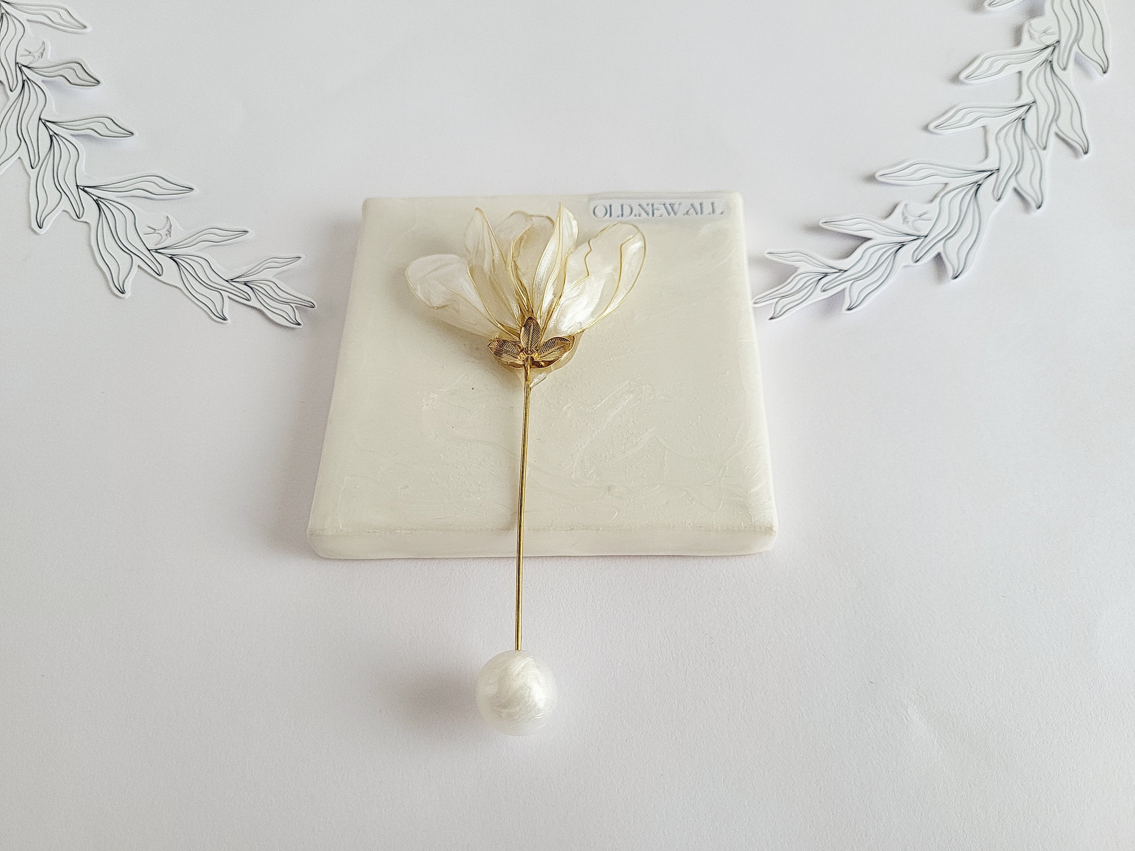 Handcrafted extra large mother of pearl silk flower brooch in white orchid design with gold wire petals and secure pin findings.
