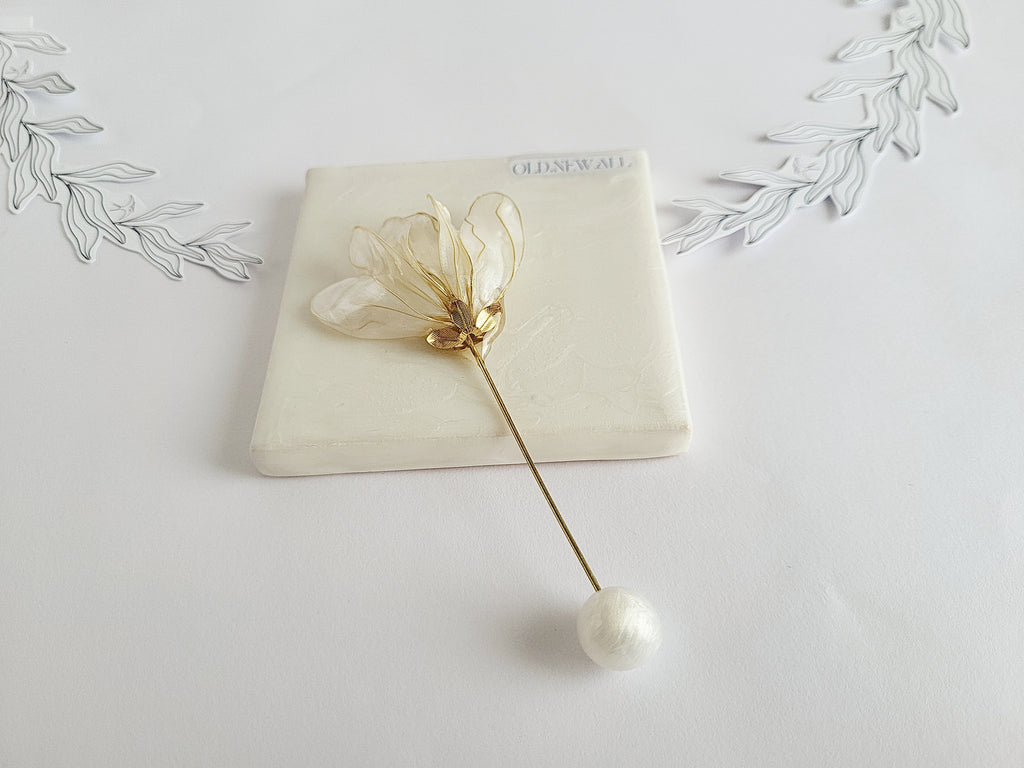 Handcrafted extra large mother of pearl silk flower brooch in white orchid design with gold wire petals and secure pin findings.