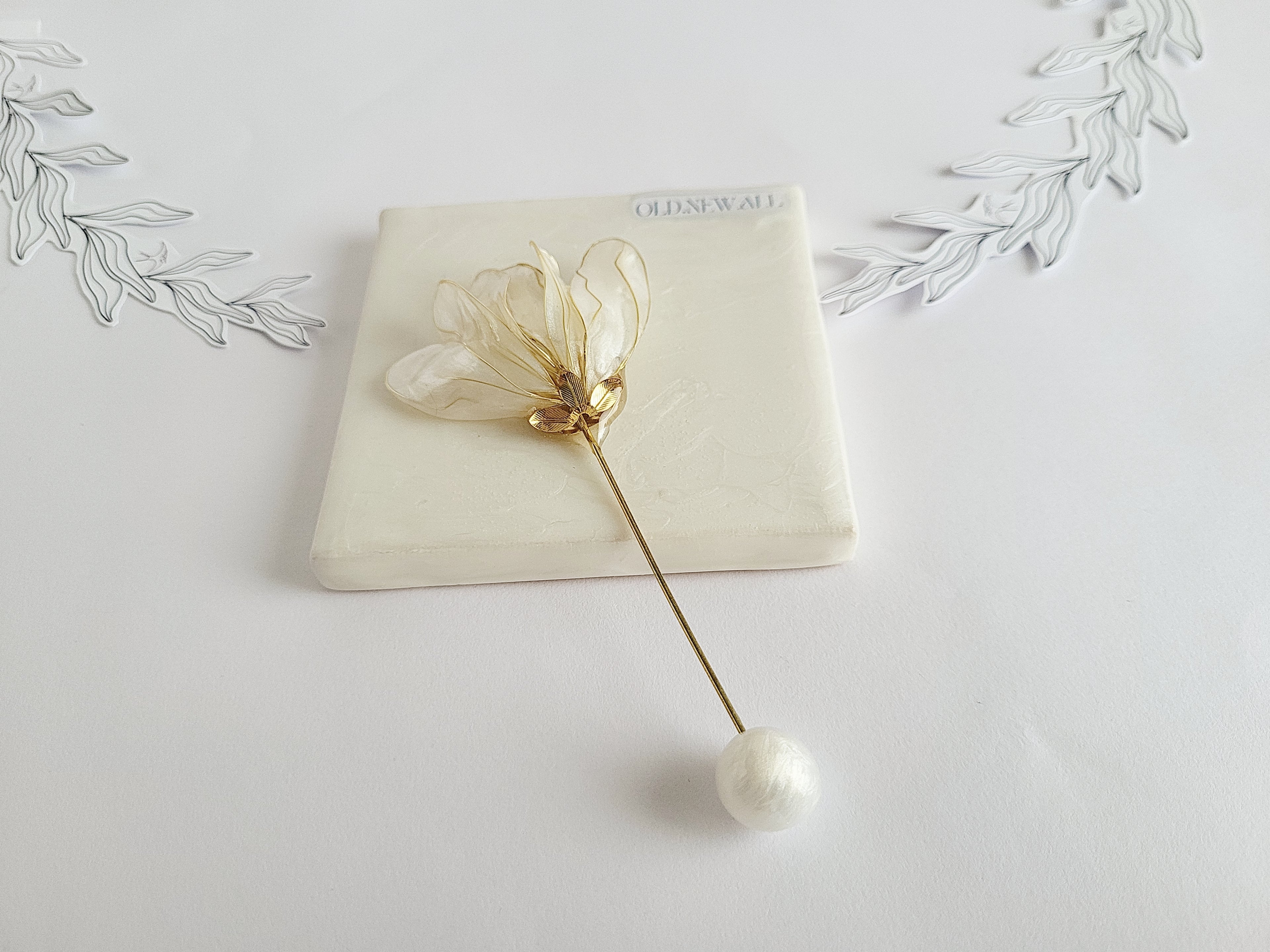 Handcrafted extra large mother of pearl silk flower brooch in white orchid design with gold wire petals and secure pin findings.
