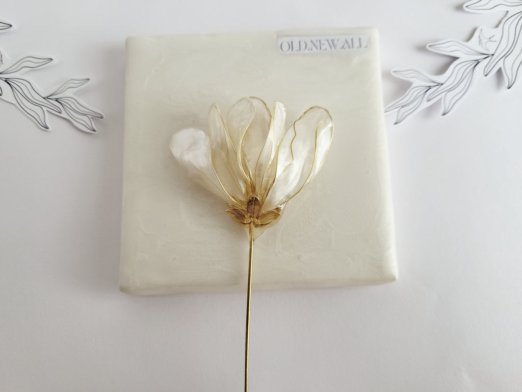Handcrafted extra large mother of pearl silk flower brooch in white orchid design with gold wire petals and secure pin findings.