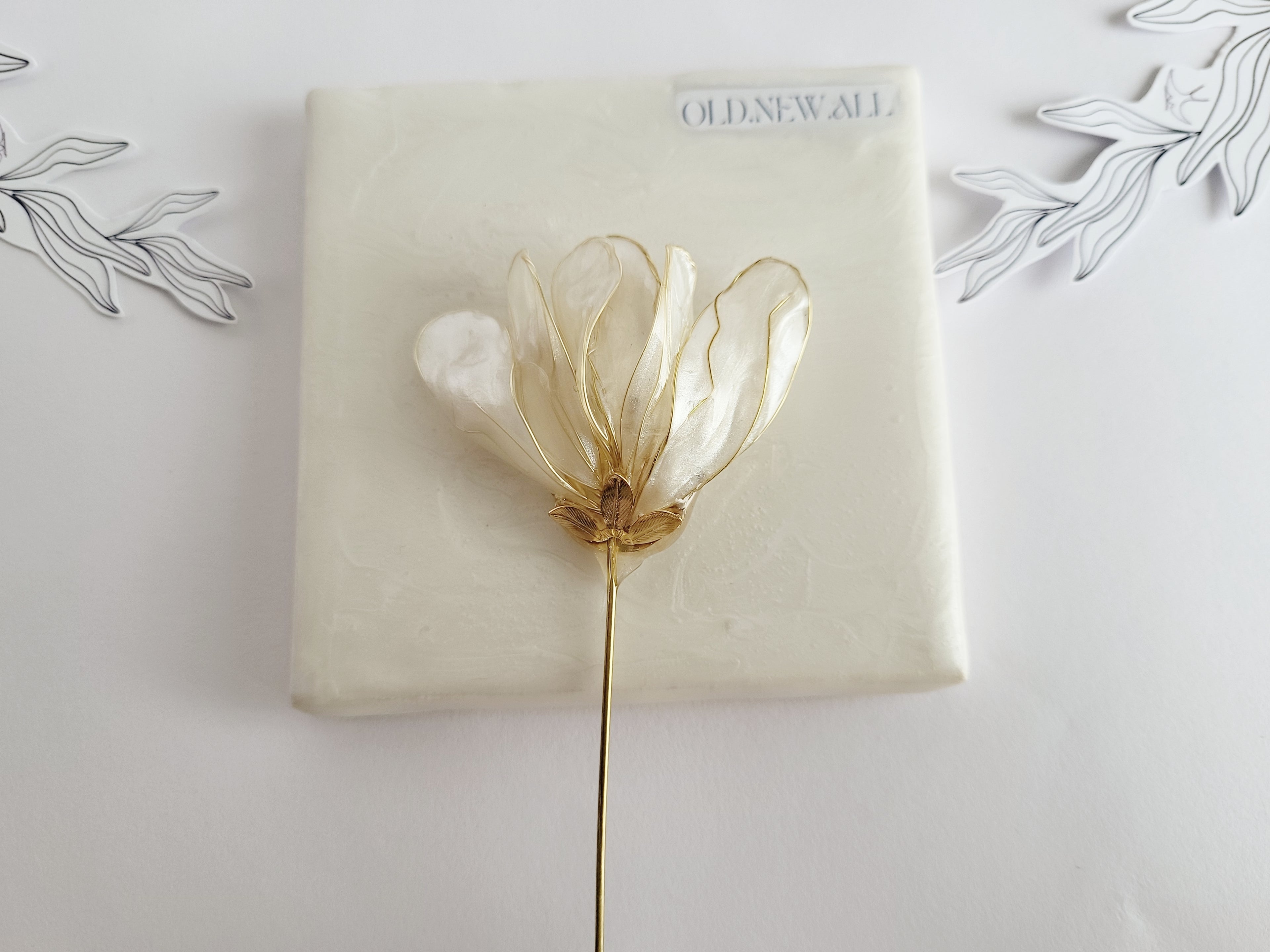 Handcrafted extra large mother of pearl silk flower brooch in white orchid design with gold wire petals and secure pin findings.