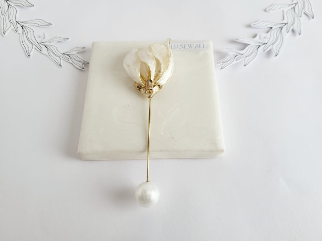 Handcrafted extra large mother of pearl silk flower brooch in white orchid design with gold wire petals and secure pin findings.