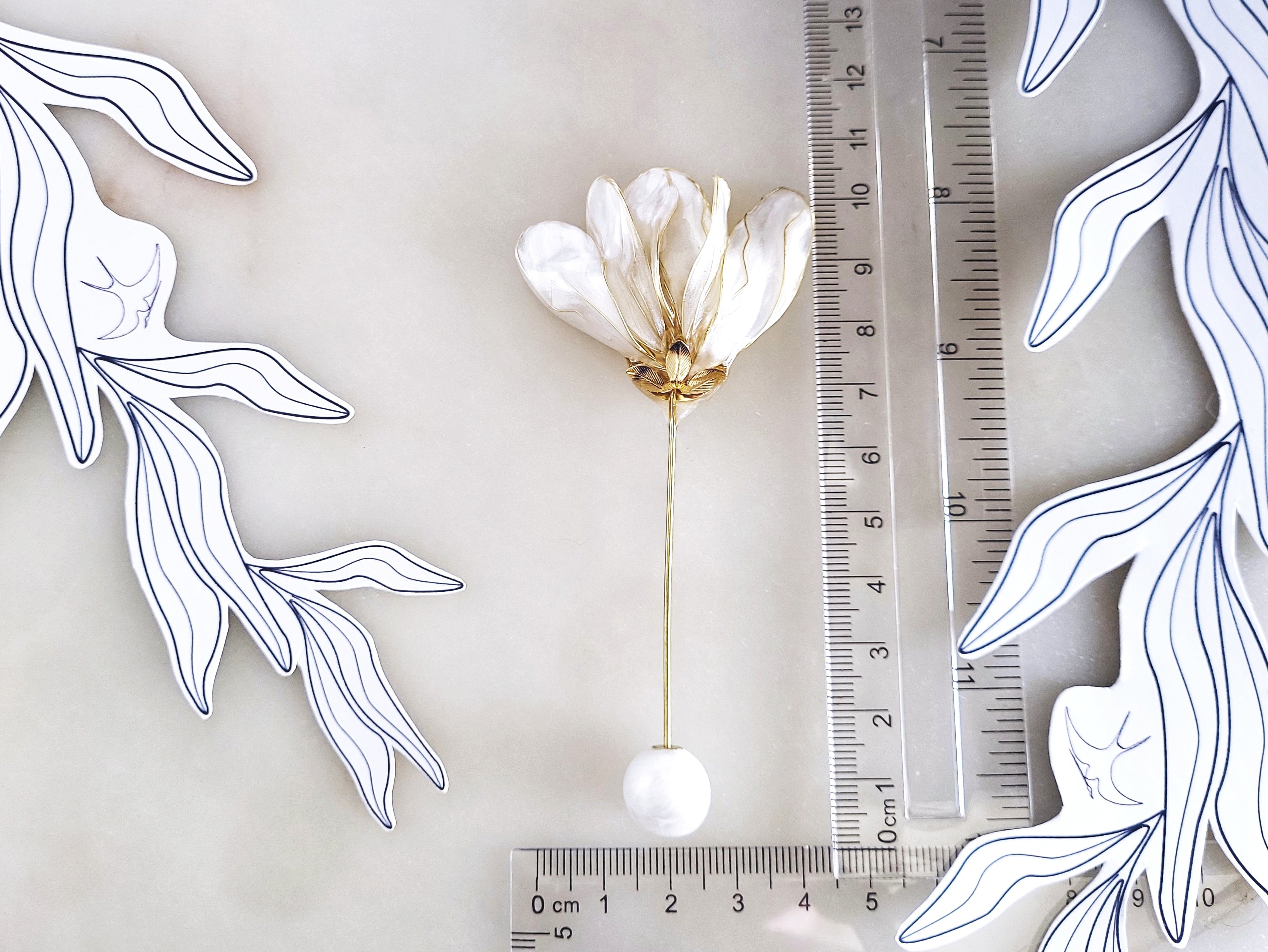 Handcrafted extra large mother of pearl silk flower brooch in white orchid design with gold wire petals and secure pin findings with ruler.