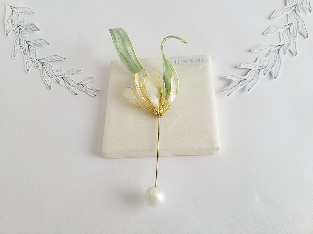 Handcrafted extra large mother of pearl silk flower brooch in white orchid design with gold wire petals and secure pin findings.