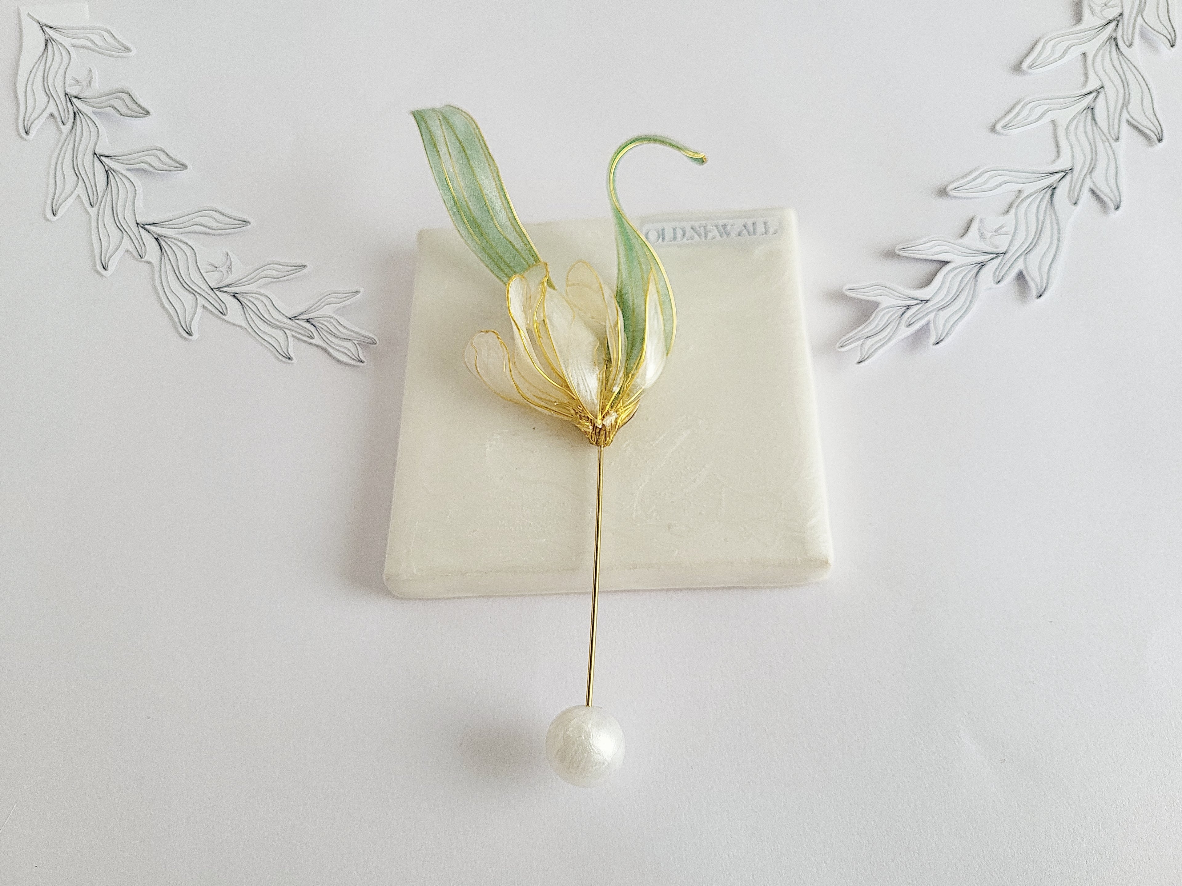 Handcrafted extra large mother of pearl silk flower brooch in white orchid design with gold wire petals and secure pin findings.