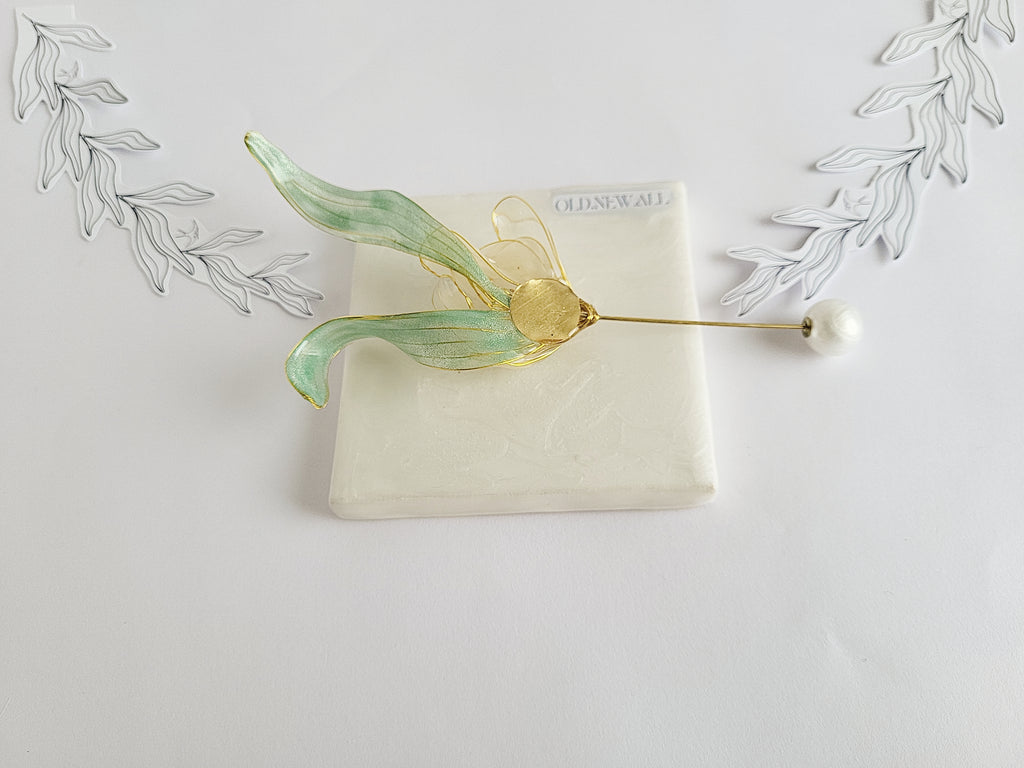 BACK of Handcrafted extra large mother of pearl silk flower brooch in white orchid design with gold wire petals and secure pin findings.