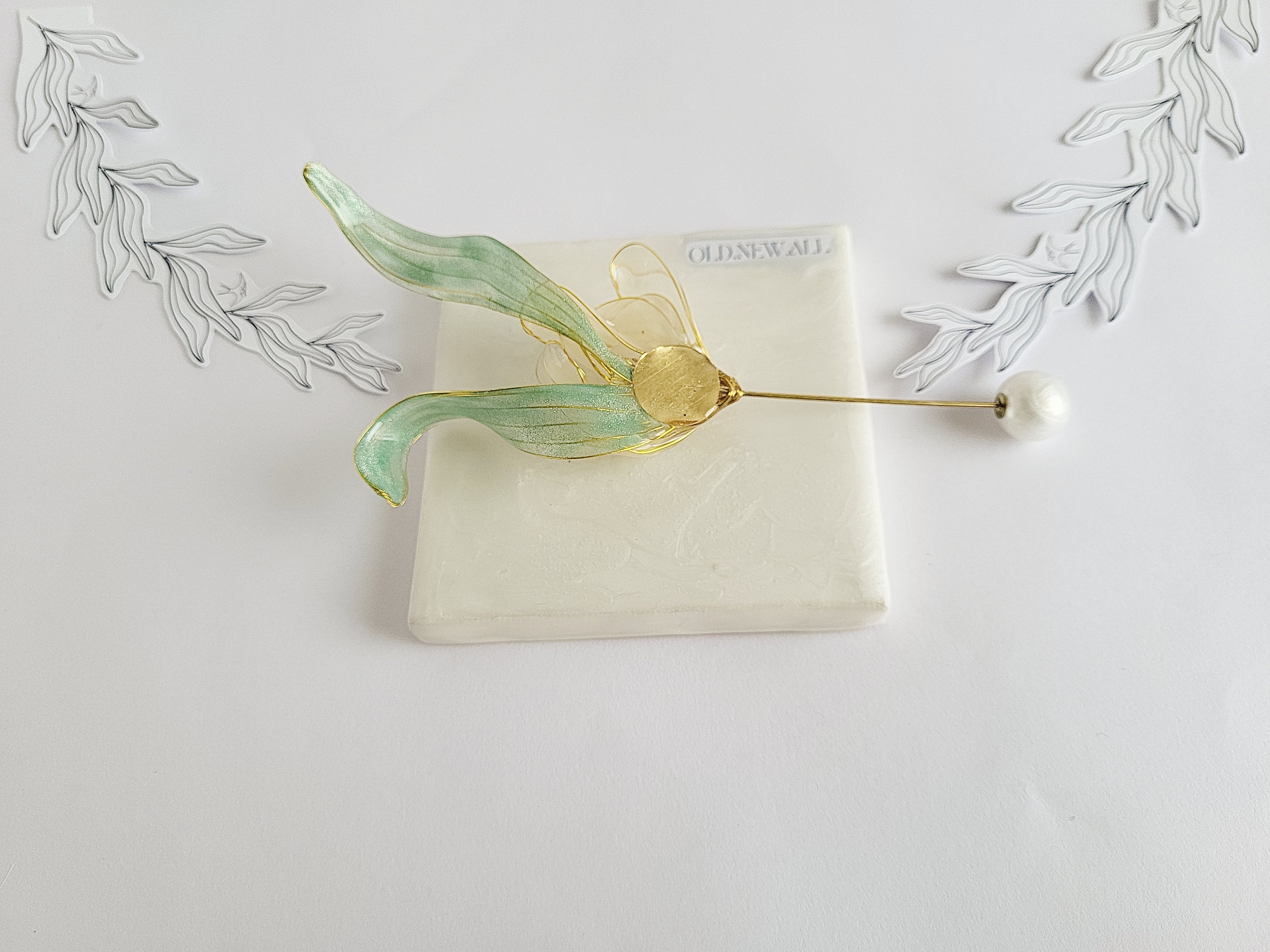 BACK of Handcrafted extra large mother of pearl silk flower brooch in white orchid design with gold wire petals and secure pin findings.