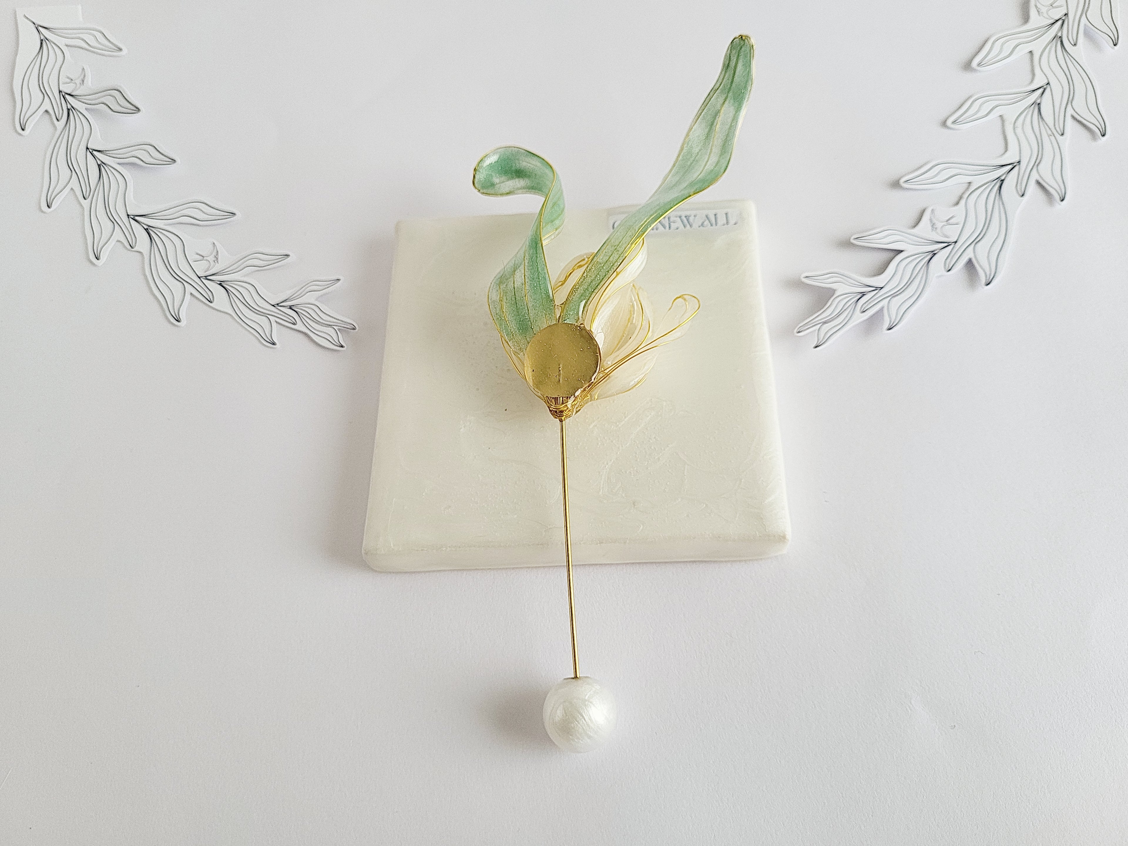 BACK of Handcrafted extra large mother of pearl silk flower brooch in white orchid design with gold wire petals and secure pin findings.
