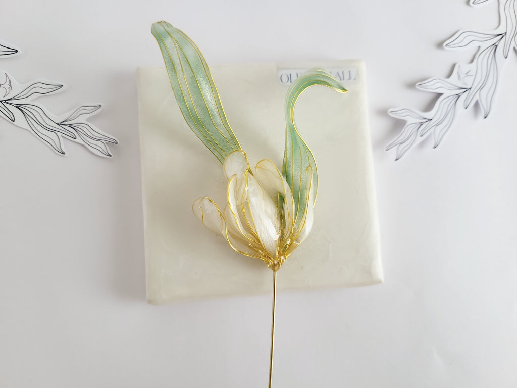 Handcrafted extra large mother of pearl silk flower brooch in white orchid design with gold wire petals and secure pin findings.