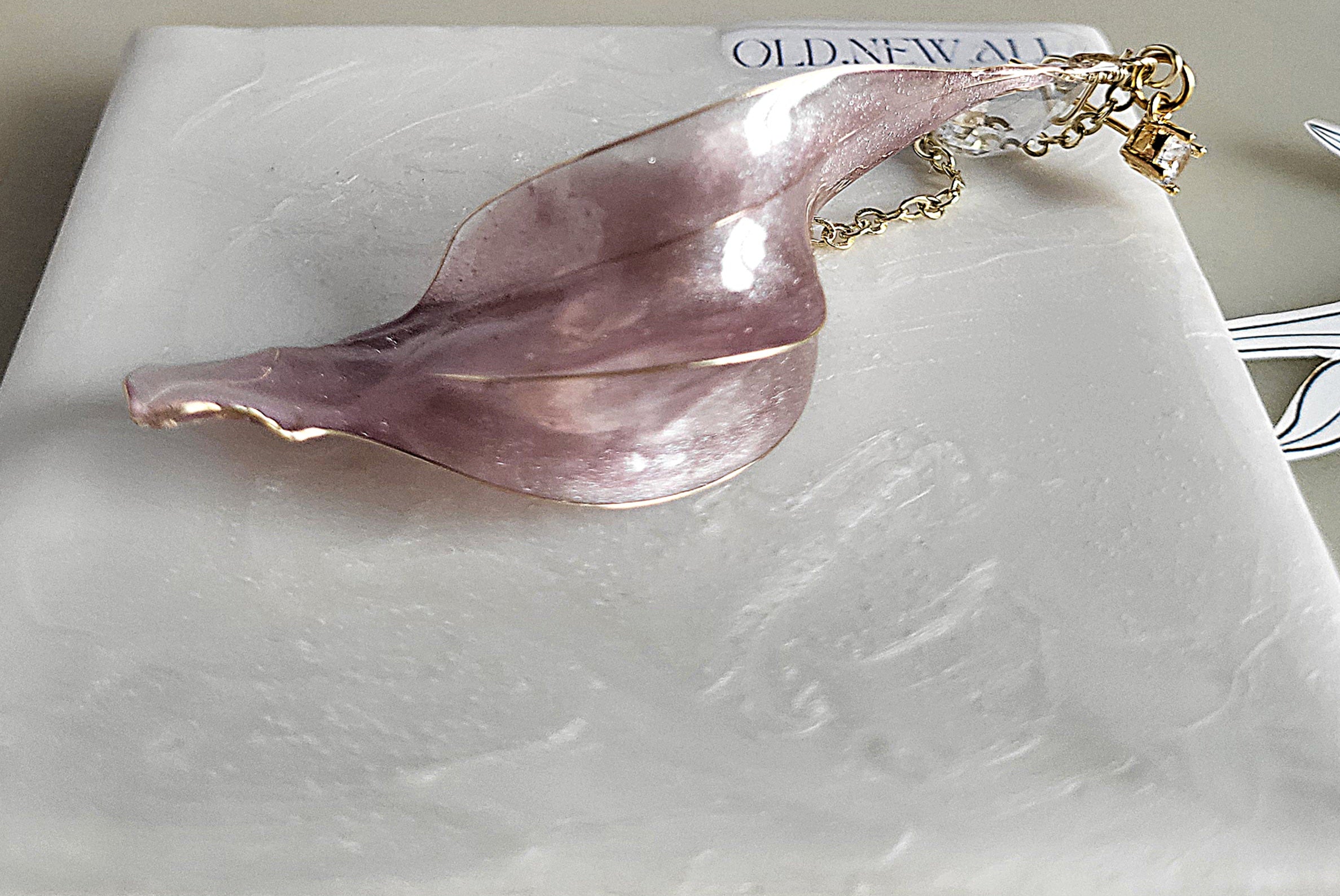 Handcrafted long golden wire earrings featuring pink cat eye resin flowers on a delicate chain with zirconia studs, waterdrop crystals, and raindrop dangles.